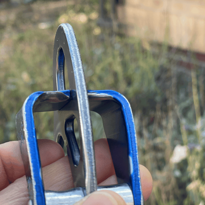 Petzl's Reverso belay device with a sharp edge worn down by a rope.